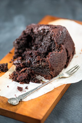 Healthy Vegan Chocolate Loaf (Cake) Broken into Pieces on Dark Grey Background