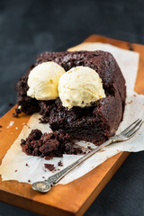 Healthy Vegan Chocolate Loaf (Cake) with Vanilla Ice-Cream Scoops on Dark Grey Background