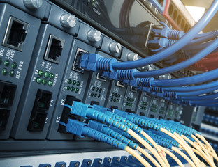 Fiber Optic cables connected to an optic ports and Network cable