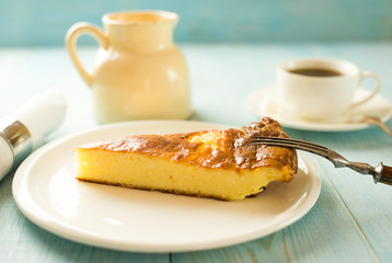 A piece of cottage cheese cake on a white plate