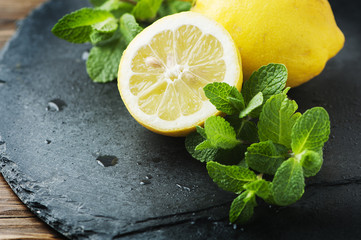 Yellow lemon and green mint on the table