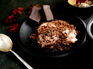 balls ice cream, vanilla sticks  , anise and chocolate on a dark background