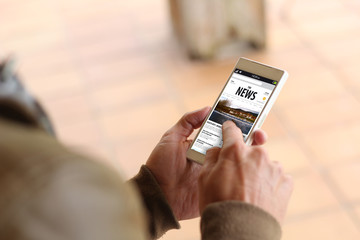 Brown young man news smartphone