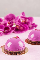 French mousse cakes on pink background