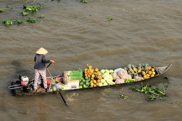 Buying and selling agricultural products on river crowded with boats fruit, flowers, agricultural products on busiest floating market in Soc Trang, Vietnam