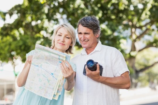 Couple looking at map in city