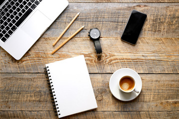 Working place with notebook on wooden table