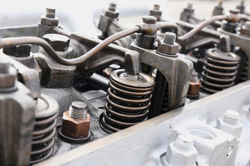 springs on the cylinder head of the engine of the tractor
