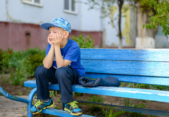 Bored little boy sitting waiting