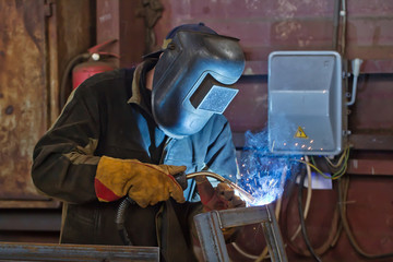 welder fabricates steel structures