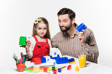Father and daughter playing educational games together 