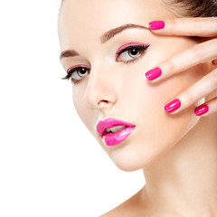 eautiful woman face with pink makeup of eyes and nails.
