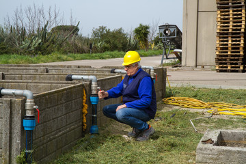 plumber at work in wastewater treatment plant