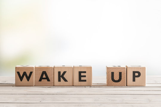 Wake up sign with wooden cubes