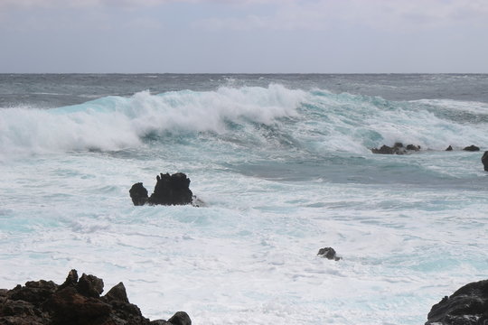 Fototapeta Wild sea with breaking waves on black lava rocks on the east coast of Lanzarote, Canary Islands, Spain. In the Northeast of the Island between Arrieta and Orzola.. 