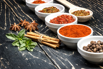 Colorful aromatic Indian spices and herbs on an old  oak wooden brown backgrownd  