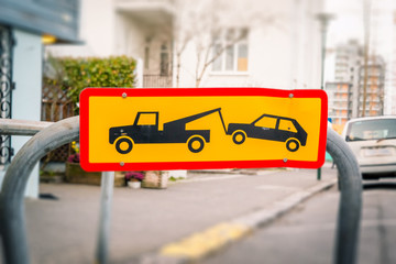 Street sign of a car being removed