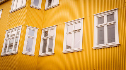 White windows on a yellow facade