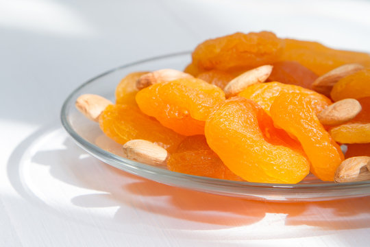 A handful of dried fruit, dried apricots and apricot seeds