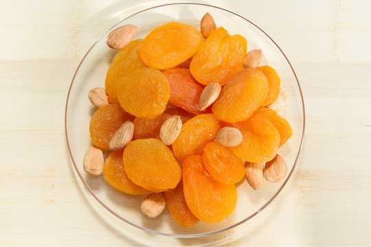 A handful of dried fruit, dried apricots and apricot seeds
