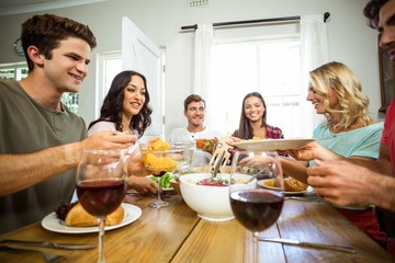 Happy friends having lunch at table