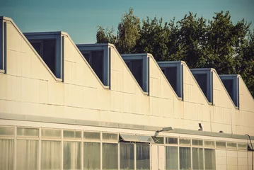 Photo sur Plexiglas Bâtiment industriel Sawtooth roof line of an old industrial building, vintage filtered style  