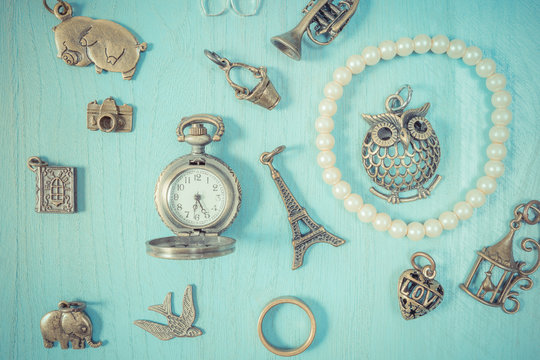 Jewellery charm on a blue wooden background