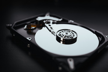 Disassembled hard drive from the computer (hdd) with mirror effects. Part of computer (pc, laptop)