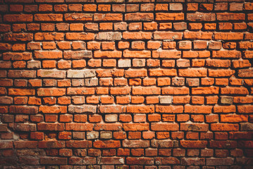 Weathered texture of stained old dark brown and red brick wall background