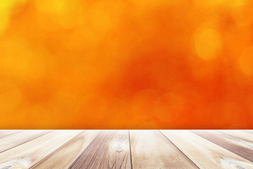 
Close up Black wooden table with orange bokeh blurred background