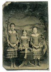 Fototapeta na wymiar Tintype, circa 1880, USA, of three girls posed in studio