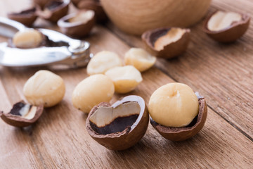 Fototapeta na wymiar close up macadamia nut oil on the wooden plate, healthy concept
