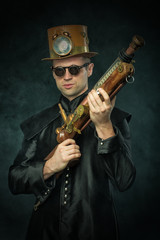 Fototapeta na wymiar Steampunk man in a hat with gun