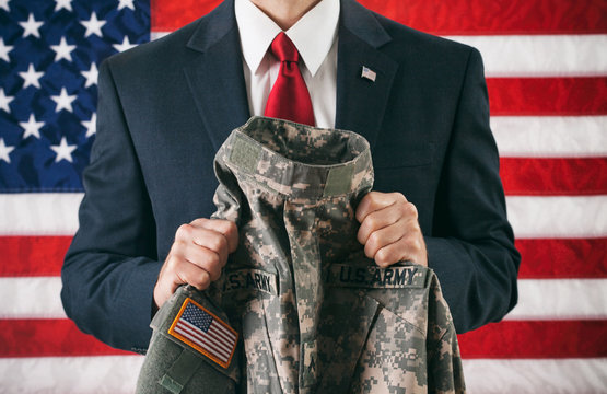 Politician: Holding A Military Uniform Jacket