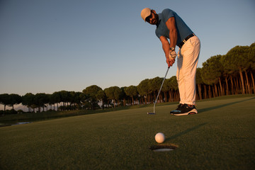 golfer  hitting shot at golf course