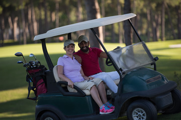 couple in buggy on golf course