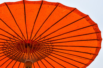 Orange color umbrella in a sunny afternoon