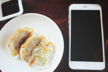 Steamed dumplings with smart phone