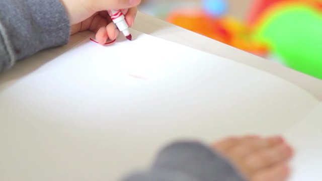 Child writing the word school on exercise book
