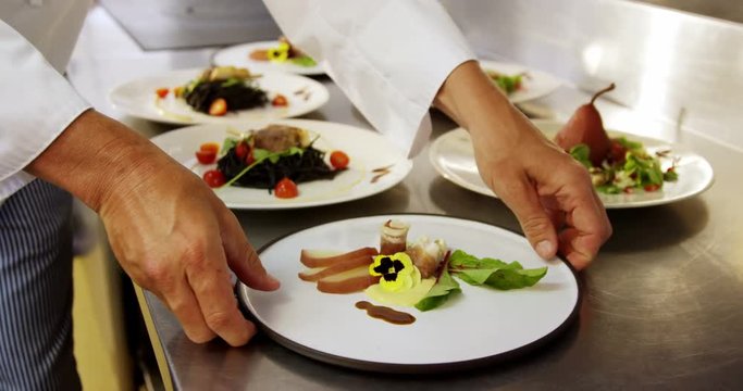 Chefs taking dishes from counter