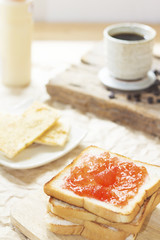 Bread with and homemade jam in on wooden table, closeup.