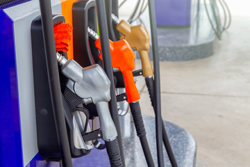 Gas pump nozzles in a service station