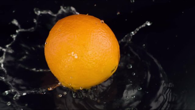 Orange drops on a wet black table