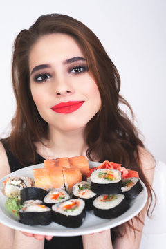 Young woman eating sushi at Japanese restaurant