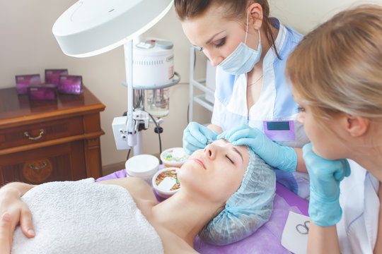 Beautiful woman in spa salon receiving epilation or correction e