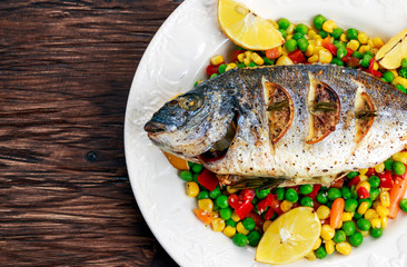 Sea bream baked with herbs and lemon, vegetable mix. 
