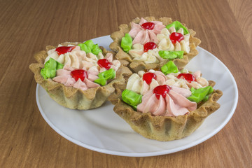 Three tasty Cake basket with cream and jam