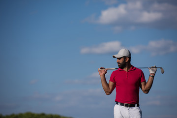 handsome middle eastern golf player portrait at course