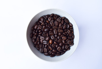 Coffee beans on white bowl