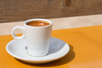 cup of coffee on yellow table